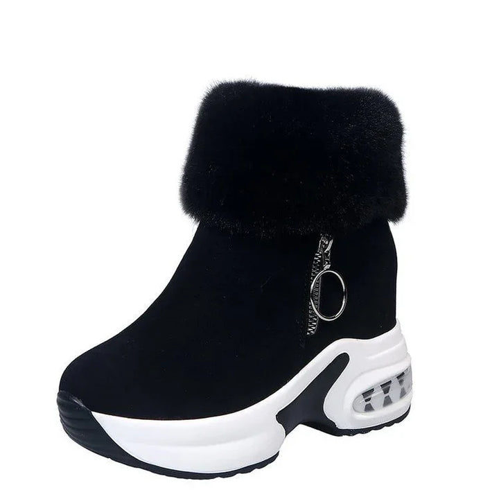 Black wedge sneaker boot with white sole, faux fur cuff, and side zipper with ring pull