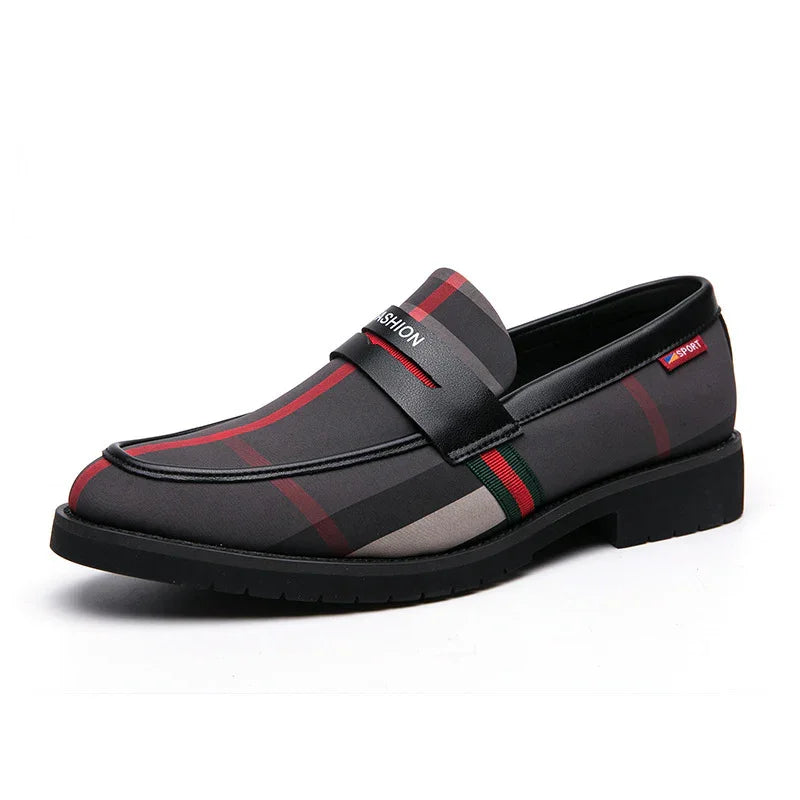 Men's black and red plaid slip-on loafer with leather strap and rubber sole on white background