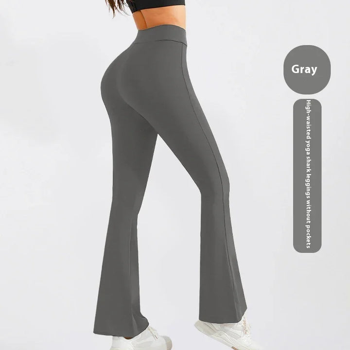 Woman wearing gray high-waisted yoga shark leggings without pockets and white sneakers