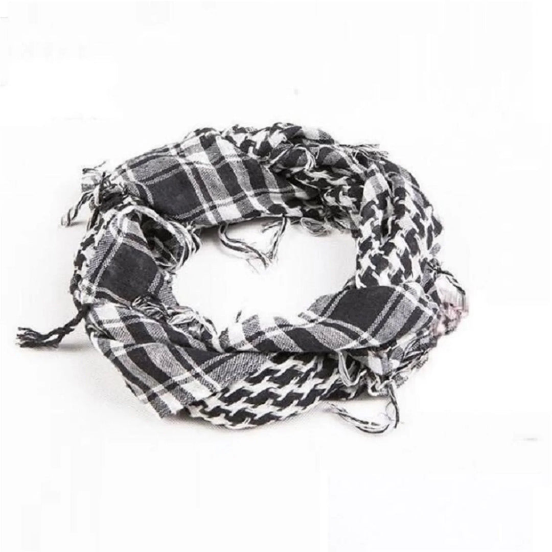 Black and white patterned shemagh scarf with frayed edges on white background