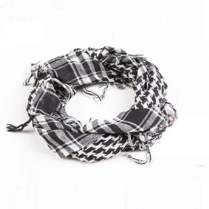 Black and white patterned shemagh scarf with frayed edges on white background