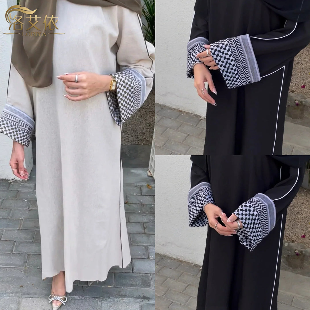 Women wearing stylish abayas with patterned cuffs in black and beige colors on outdoor pavement