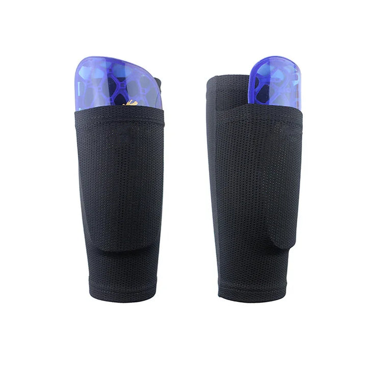 Pair of black soccer shin guard sleeves with blue shin guards partially inserted