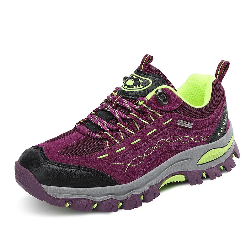 Purple and black hiking shoe with neon yellow accents and rugged sole on white background