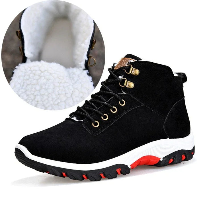 Black winter hiking boots with white fleece lining, gold eyelets, and red-black rugged sole