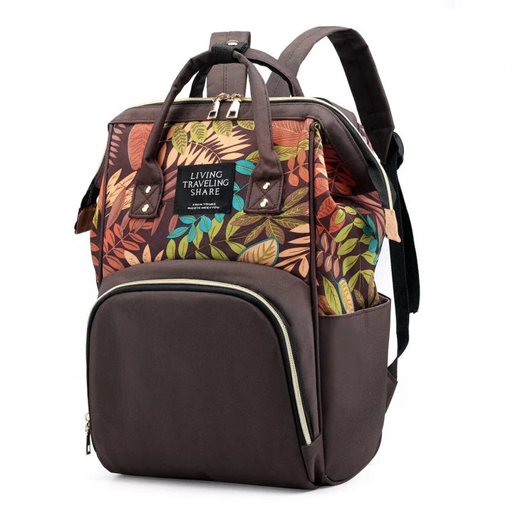 Brown backpack with colorful leaf pattern, front zipper pocket, dual handles, and adjustable straps