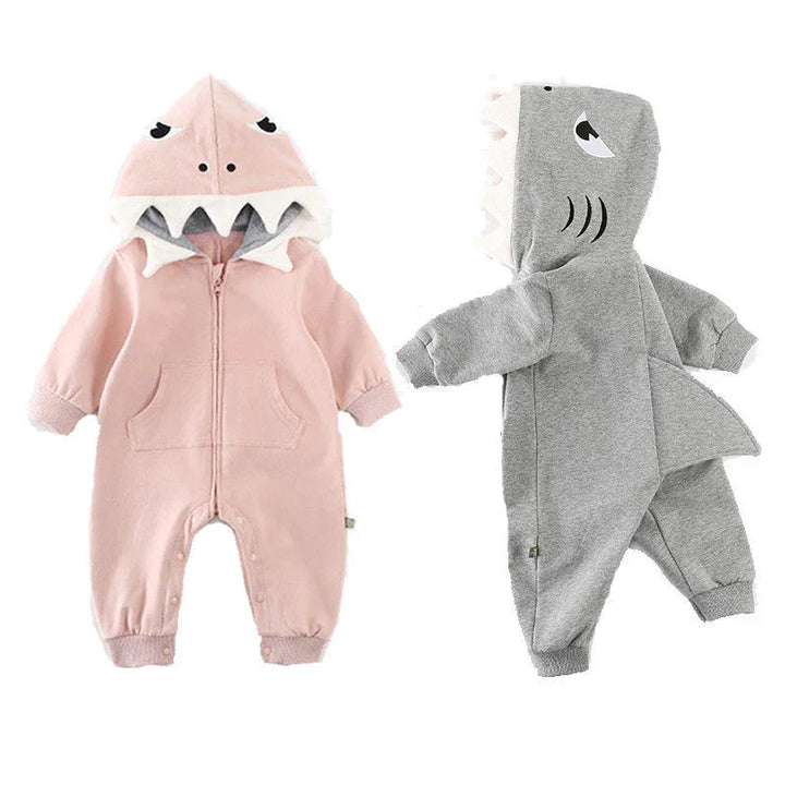Baby shark onesies in pink and gray with fin details and hood featuring shark eyes and teeth
