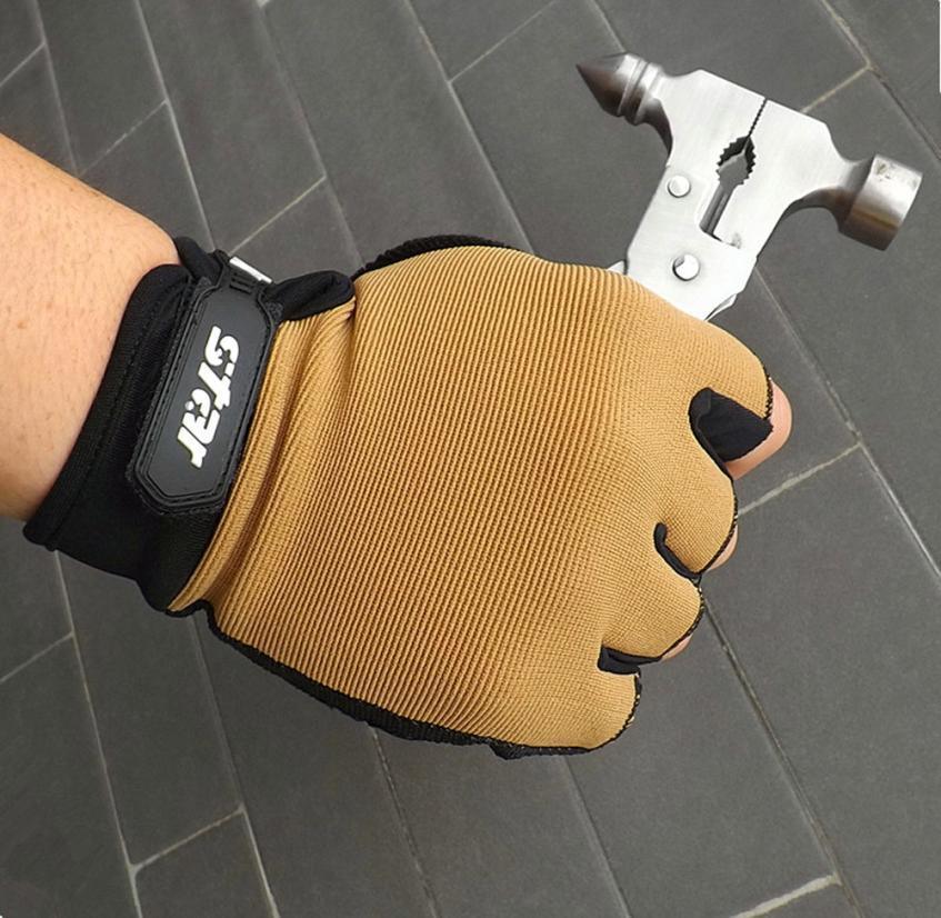 Hand in tan work glove holding multifunctional hammer tool on tiled floor