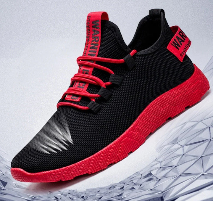 Black and red sporty sneaker with red laces and warning label on tongue and heel, textured sole