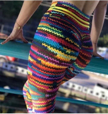 Close-up of person wearing colorful zigzag patterned leggings leaning on railing outdoors