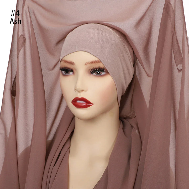Mannequin wearing ash-colored hijab with sheer fabric draped around head and shoulders
