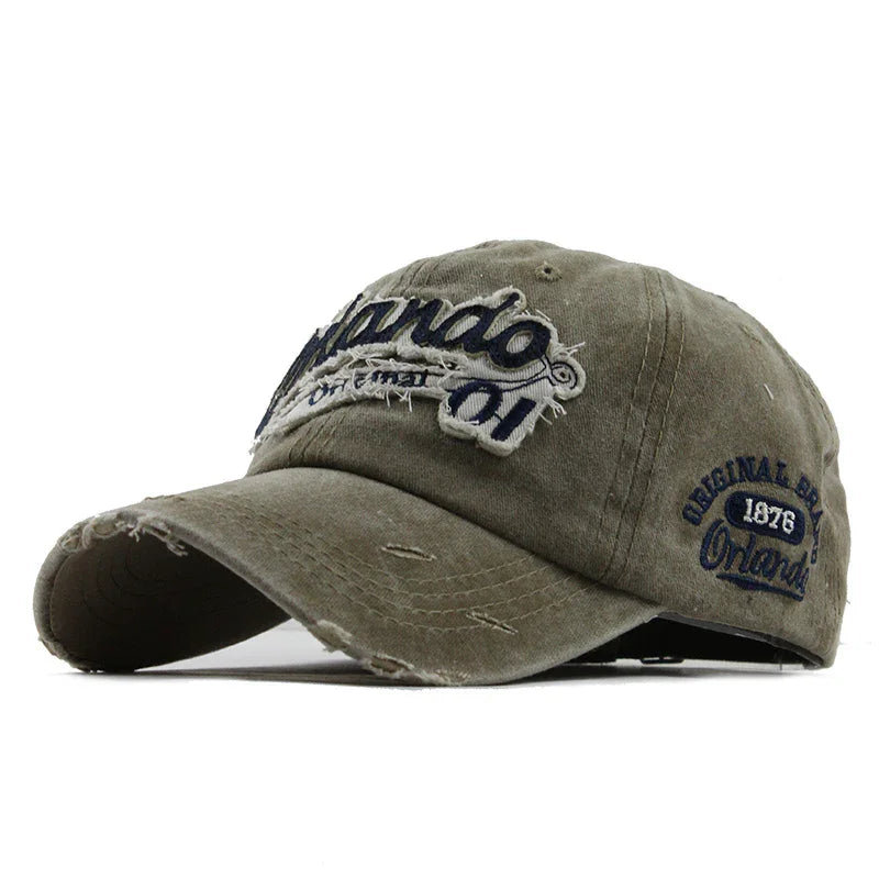 Worn olive green baseball cap with distressed edges and embroidered Orlando text and 1876 emblem