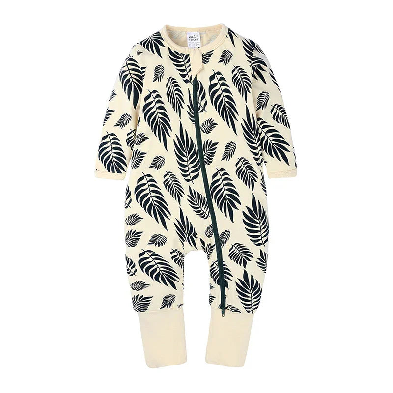 Cream baby romper with black tropical leaf print and front zipper closure