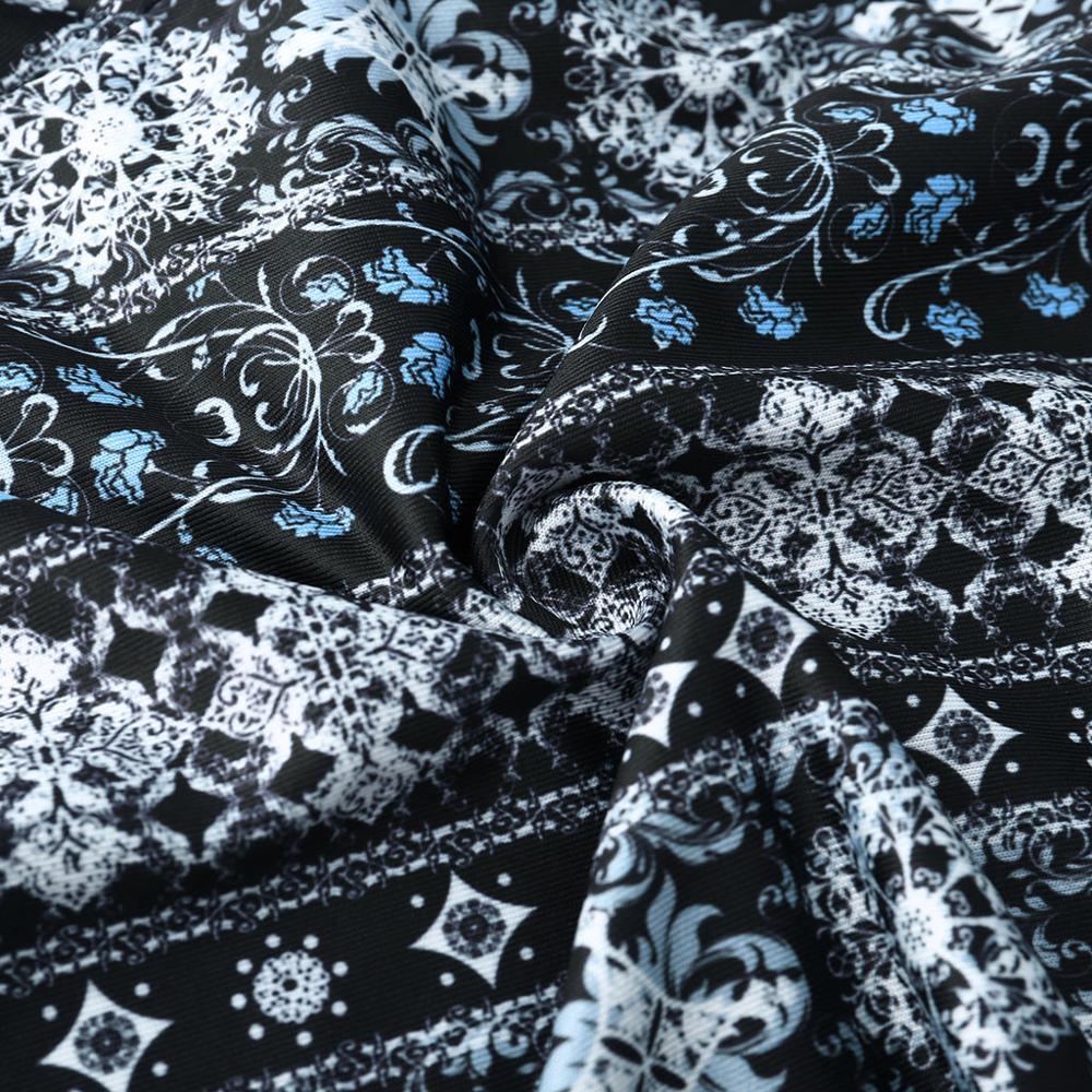 Black fabric with intricate white and blue floral and geometric pattern, softly folded