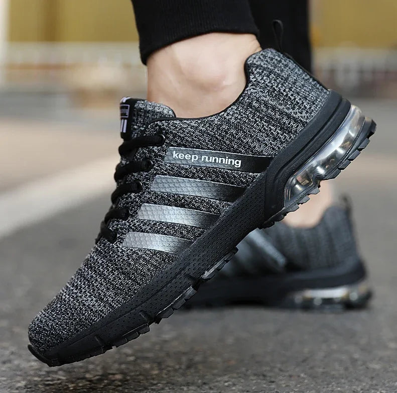 Black and gray knit running shoes with air cushion sole and keep running text on the side