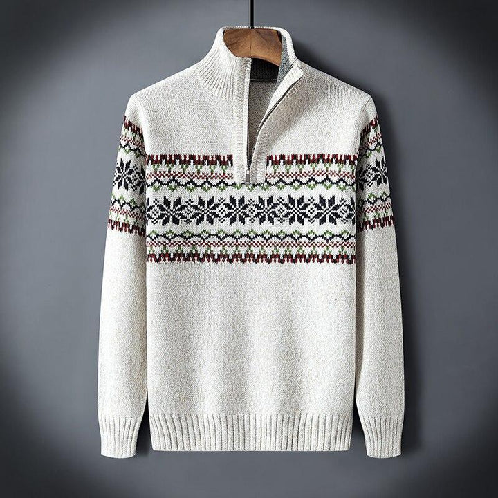 Cream knit sweater with half zipper and black, green, maroon snowflake pattern across chest and sleeves