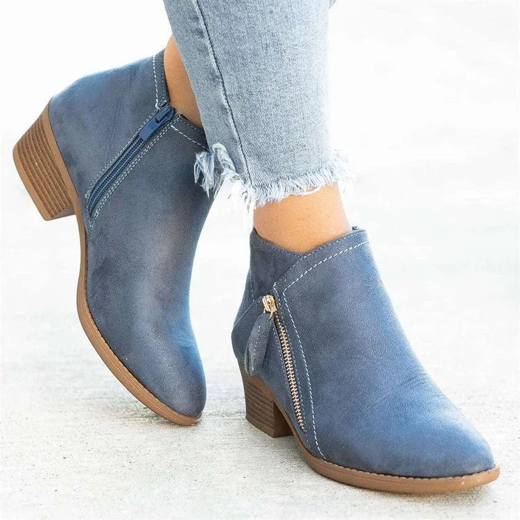 Blue suede ankle boots with side zippers and wooden low block heels worn with frayed hem jeans
