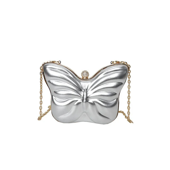 Silver butterfly-shaped clutch bag with a gold chain strap and jeweled clasp