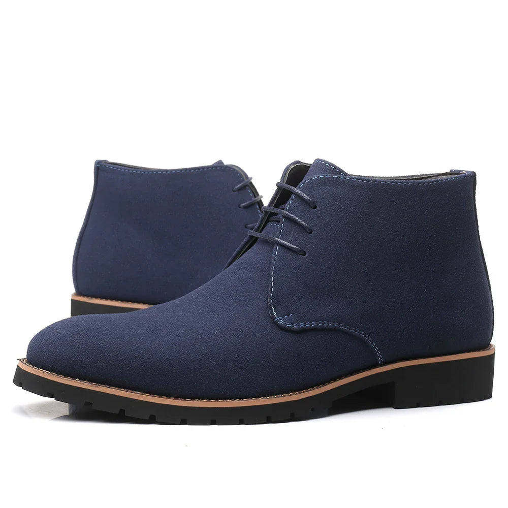 Pair of navy blue suede men's chukka boots with brown welt and black rubber sole