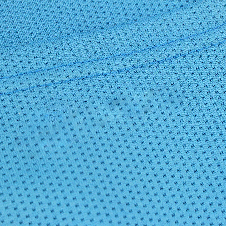 Close-up of blue athletic mesh fabric with visible stitching and textured perforations