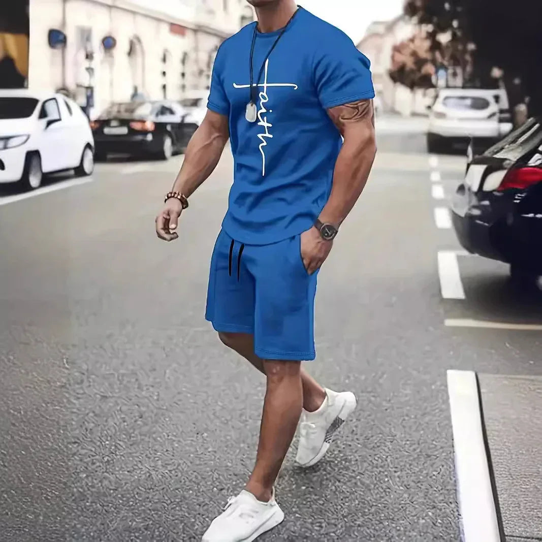 Man in blue athletic shorts and t-shirt with faith print walking on street wearing white sneakers