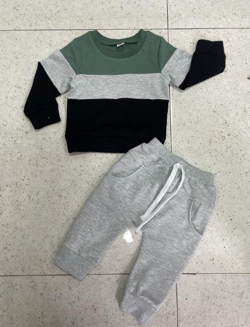 Kids colorblock sweatshirt in green, grey, black with grey jogger pants on tiled floor