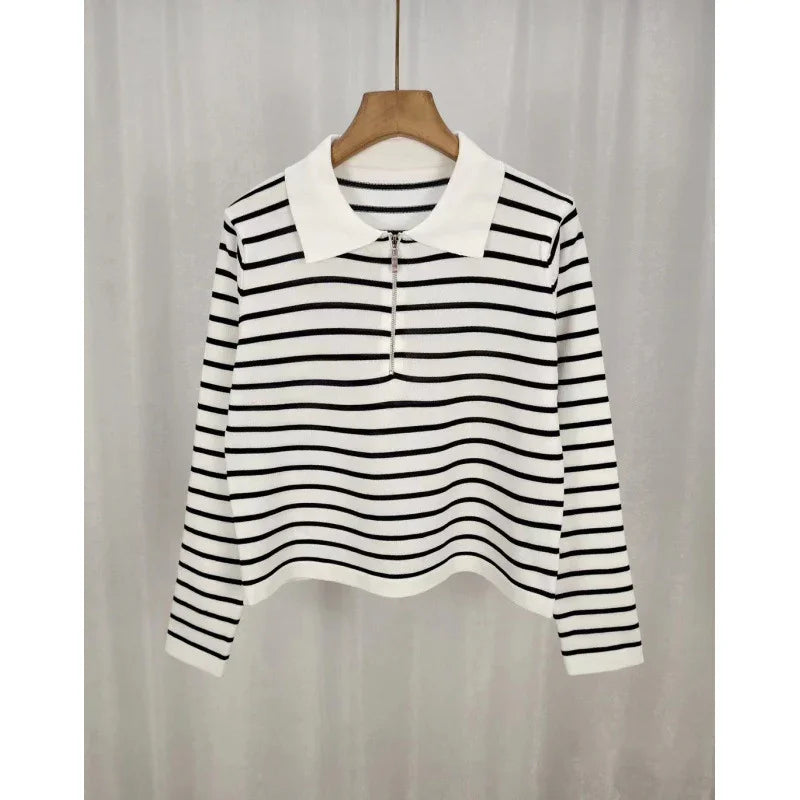 White long-sleeve knit top with black horizontal stripes and a white collar hanging on a wooden hanger