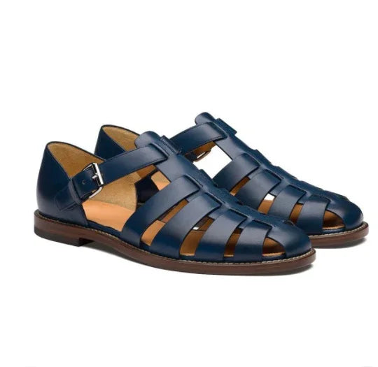 Pair of navy blue leather fisherman sandals with buckle closure and brown sole