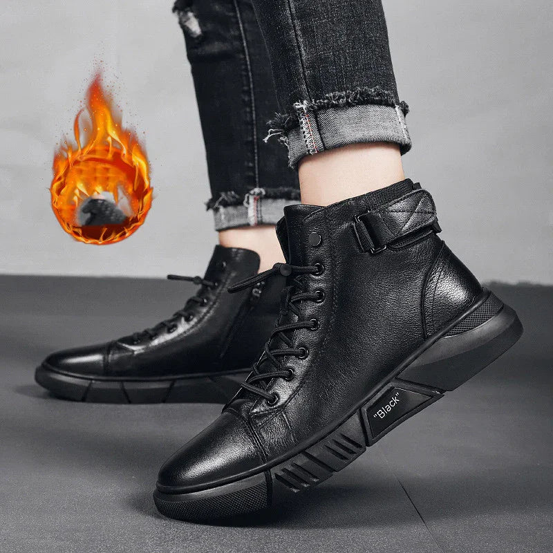 Black leather high-top sneakers with laces and buckle detail worn with rolled black jeans on gray floor