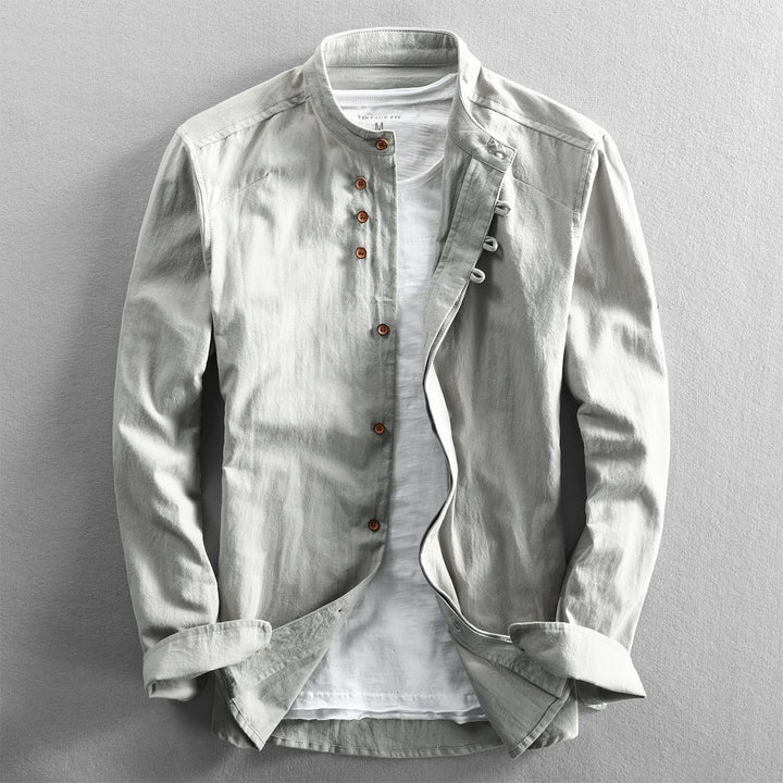 White vintage fit shirt with brown buttons over white t-shirt on gray background