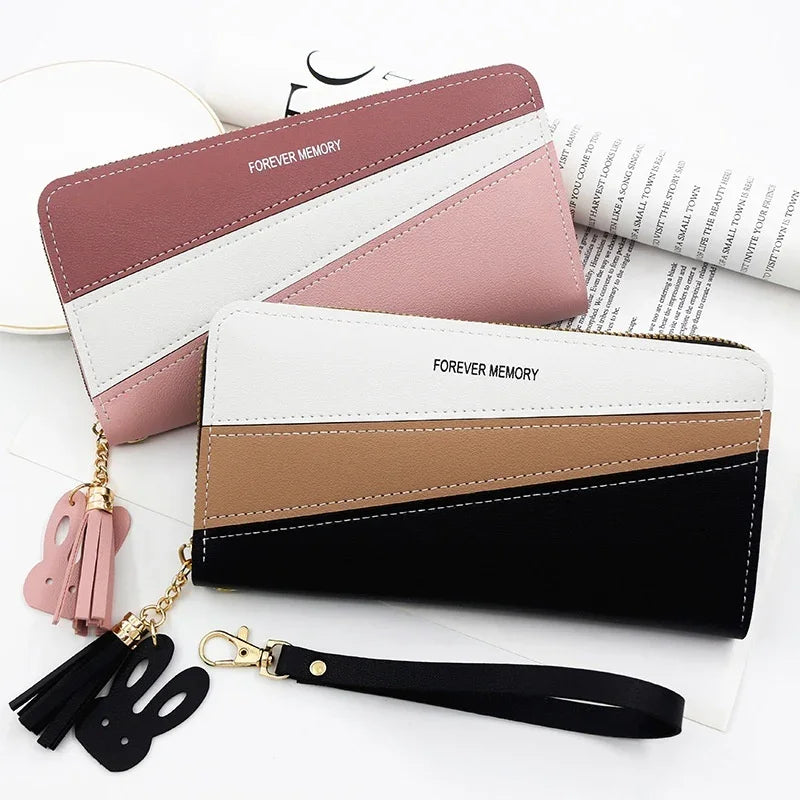 Two color-blocked wallets with 'FOREVER MEMORY' text, tassel and bunny keychains, one in pink tones, one in black and brown