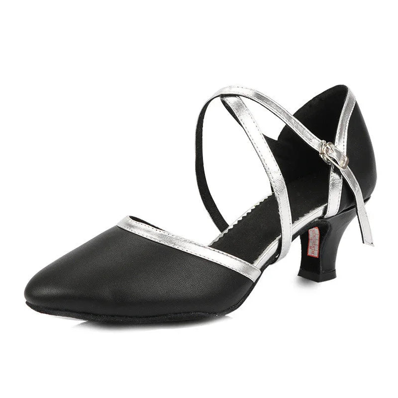 Black leather women's dress shoe with silver straps and mid heel on white background