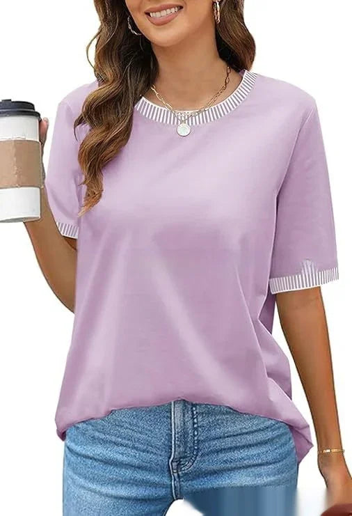 Woman wearing casual lavender t-shirt with striped neckline and cuffs, holding coffee cup