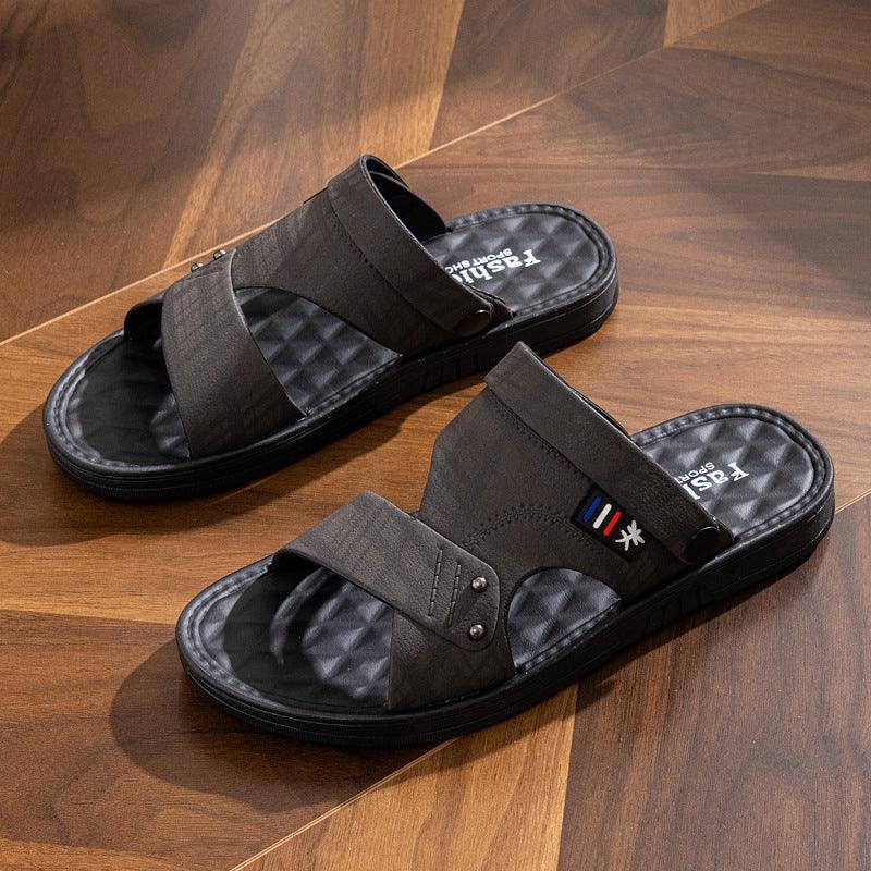 Black men's casual slip-on sandals with textured footbed on wooden floor
