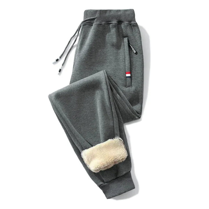 Grey fleece-lined jogger pants with drawstring waist and striped pocket detail