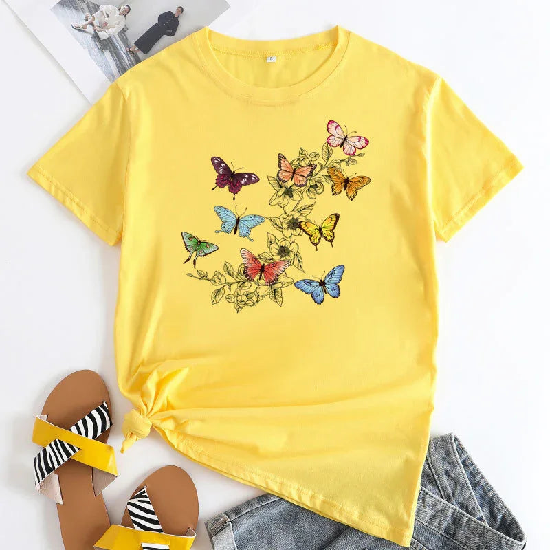 Yellow t-shirt with colorful butterfly and floral print paired with striped yellow sandals and denim shorts