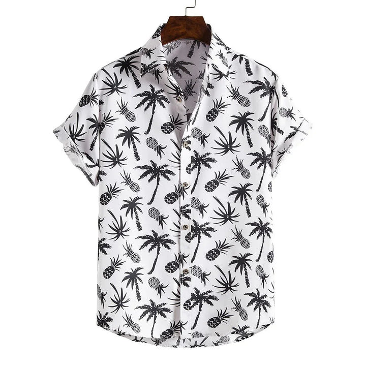 White short-sleeve button-up shirt with black palm tree and pineapple print on wooden hanger