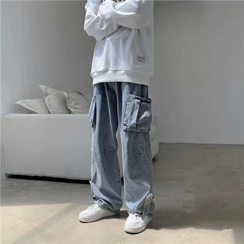 Person wearing white sweatshirt, baggy light blue denim cargo pants, and white sneakers indoors near white sofa
