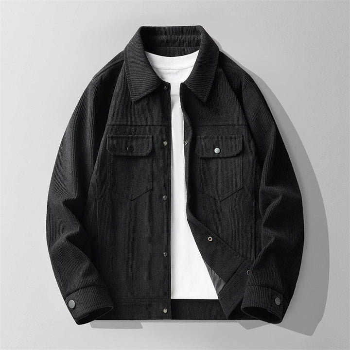Black corduroy jacket layered over a white t-shirt, laid flat on a light gray background