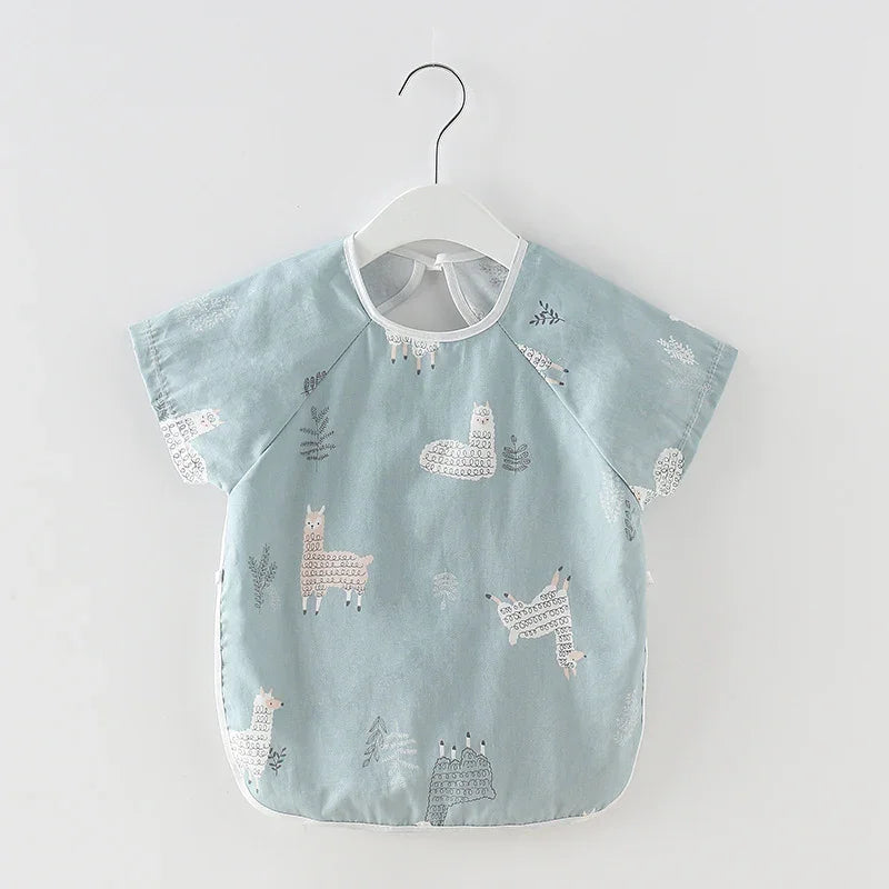 Light blue baby bib with llama and plant prints hanging on white hanger