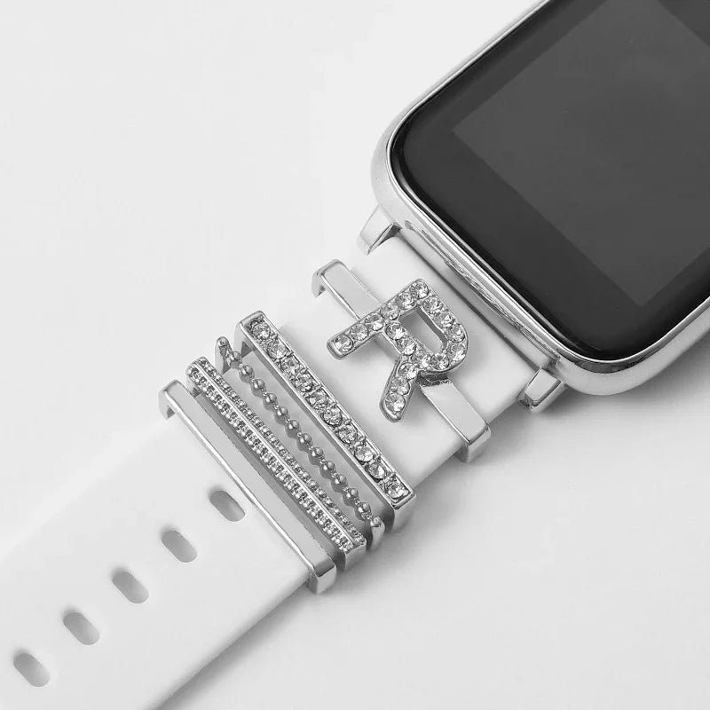 White smartwatch band with silver rhinestone charms, including letter R and decorative bars