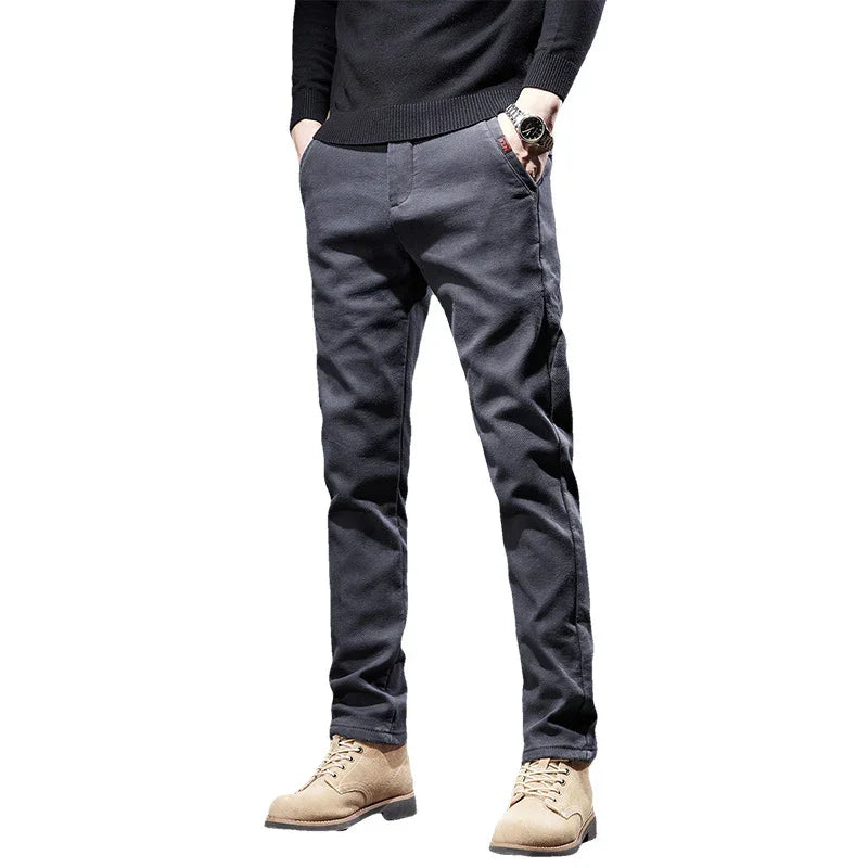 Men's casual slim-fit dark gray pants paired with beige lace-up boots and black sweater