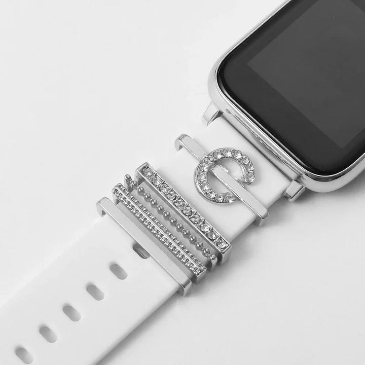 White smartwatch band with silver and rhinestone decorative charms on a white background