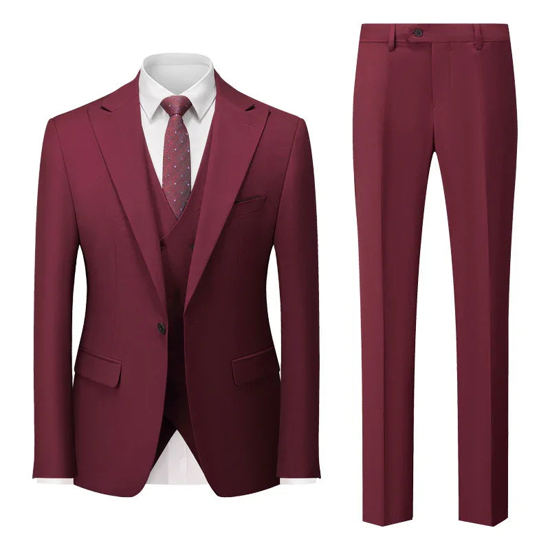 Elegant burgundy men's suit with blazer, matching pants, white shirt, and patterned tie