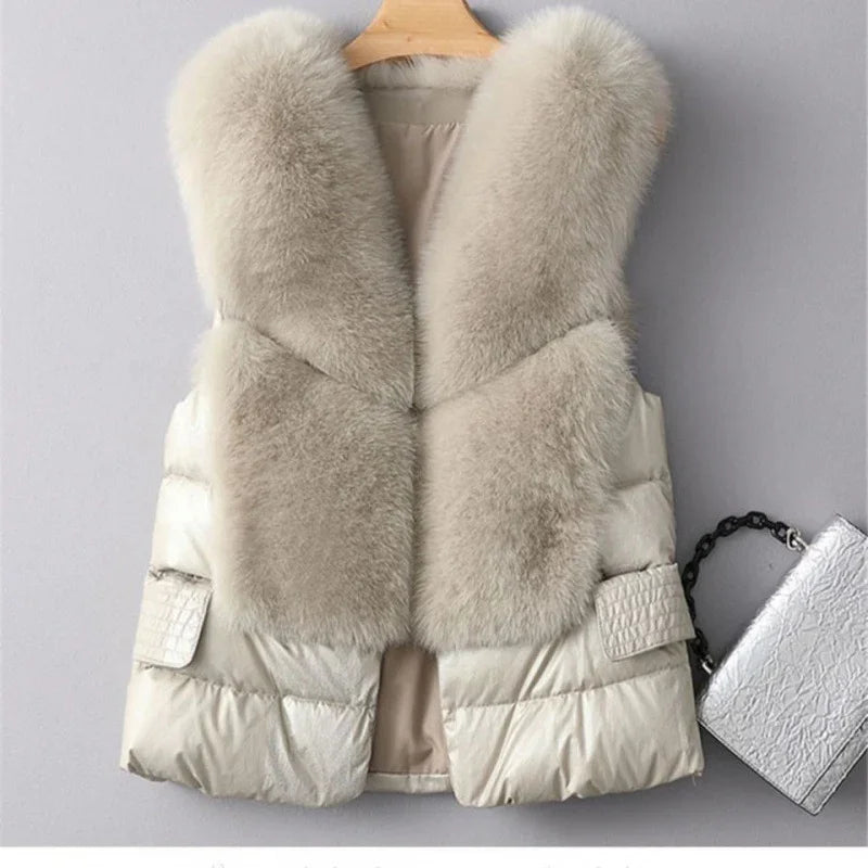 Beige sleeveless puffer vest with large soft fur collar, hanging on wooden hanger