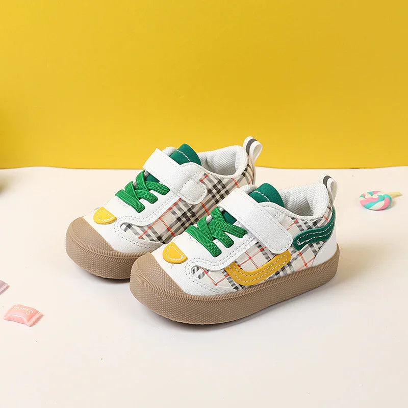 Toddler sneakers with green laces, white and plaid pattern, yellow and green accents on beige sole