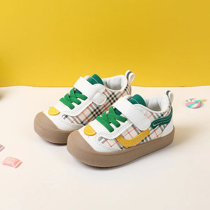 Toddler sneakers with green laces, white and plaid pattern, yellow and green accents on beige sole