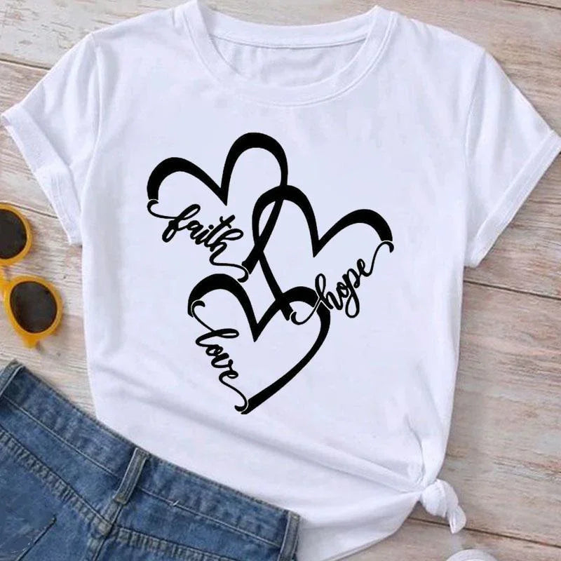 White t-shirt with intertwined black hearts and words faith, hope, love in script font, paired with blue jeans and yellow sunglasses