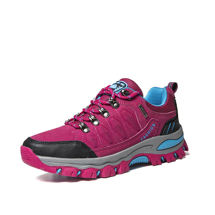 Pink and black outdoor hiking shoe with blue interior lining and rugged sole