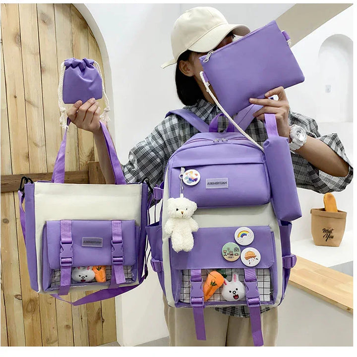 Person holding matching beige and purple backpack and tote bag with cute pins and plush toys